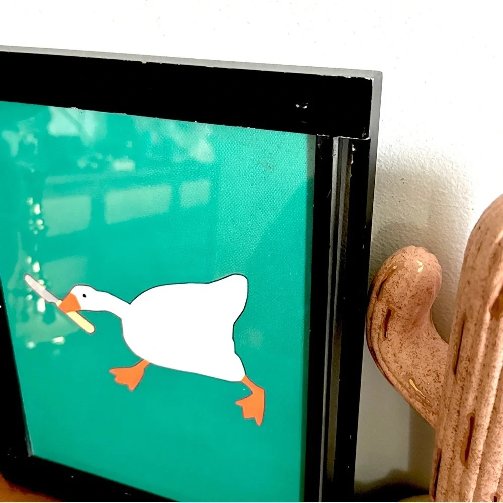 Silly Goose with a Butter Knife Green Canvas Print Black Framed Quirky Wall Art